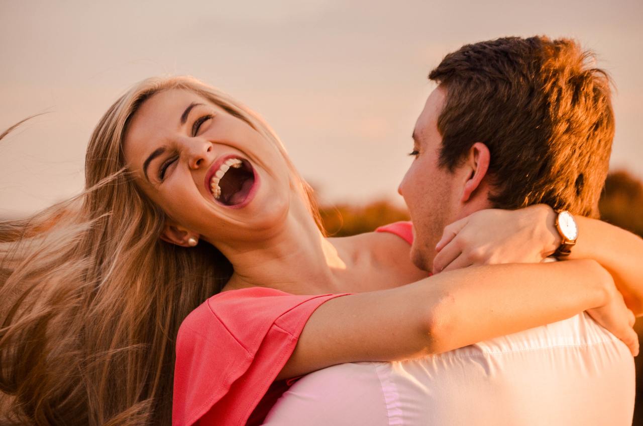 man hugging woman while smiling