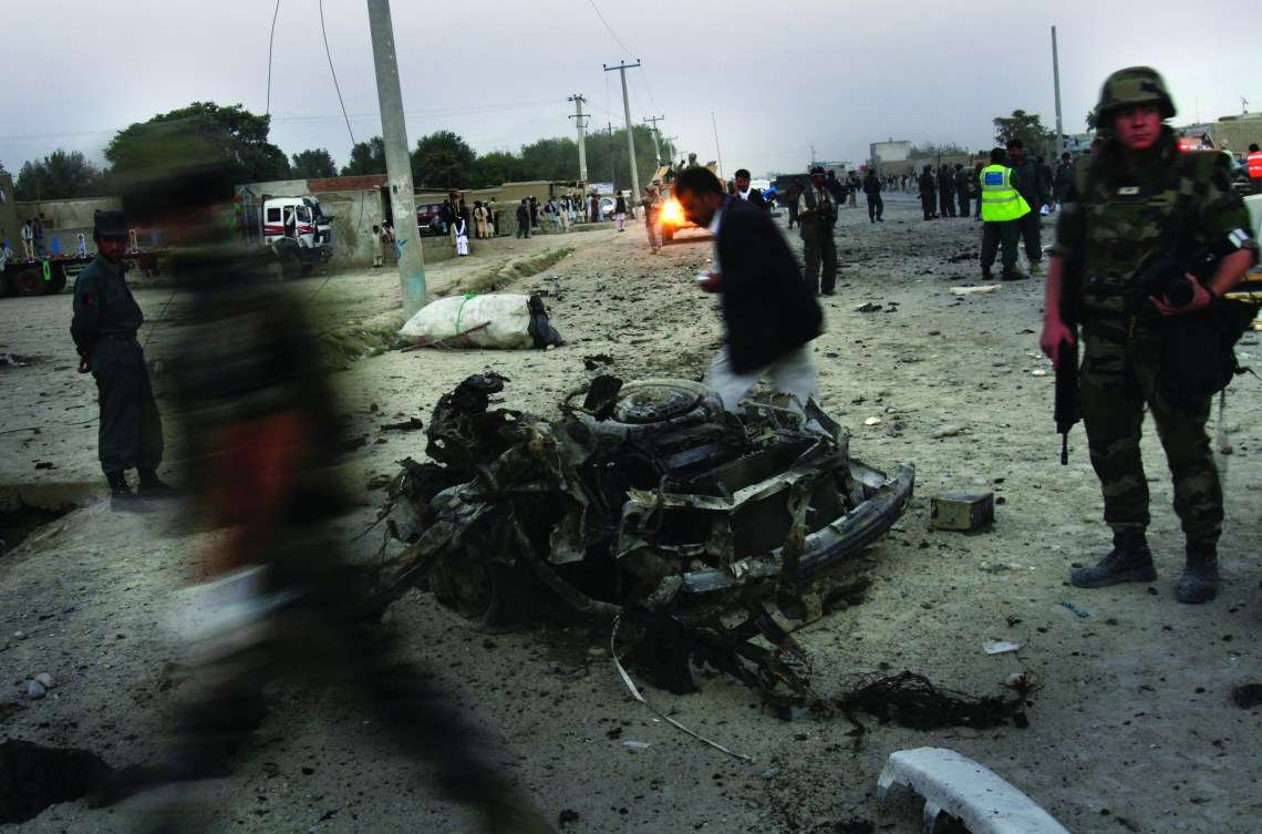 French soldiers arrive to the scene where a car bomber killed three Afghan police and wounded five people in Kabul, Afghanistan, Monday, Sept. 18, 2006. A suicide car bomber killed three Afghan police and wounded five other people in Kabul on Monday, an official said. (AP Photo/Rodrigo Abd)