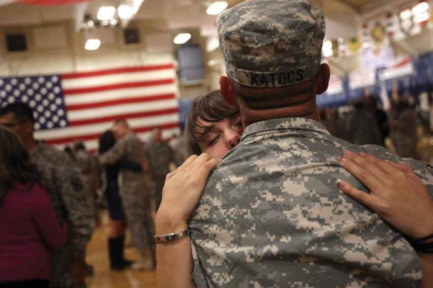 FORT CARSON, CO - NOVEMBER 10: Family members and U.S. soldiers embrace following a welcome home ceremony for troops returning from Iraq on November 10, 2011 in Fort Carson, Colorado. More than 100 soldiers from the 549th Quartermaster Company, 43rd Sustainment Brigade returned after a seven-month deployment. They played a key role in removing excess equipment from Iraq as other troops withdrew from the region. (Photo by John Moore/Getty Images)