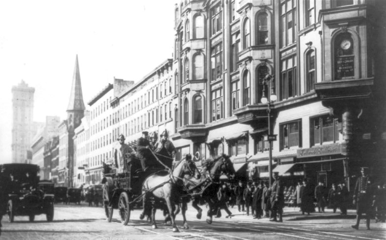 A horse-drawn fire engine en route to the burning factory