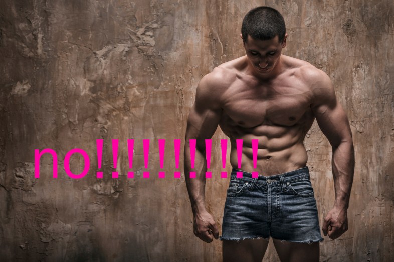 Muscular man on wall background