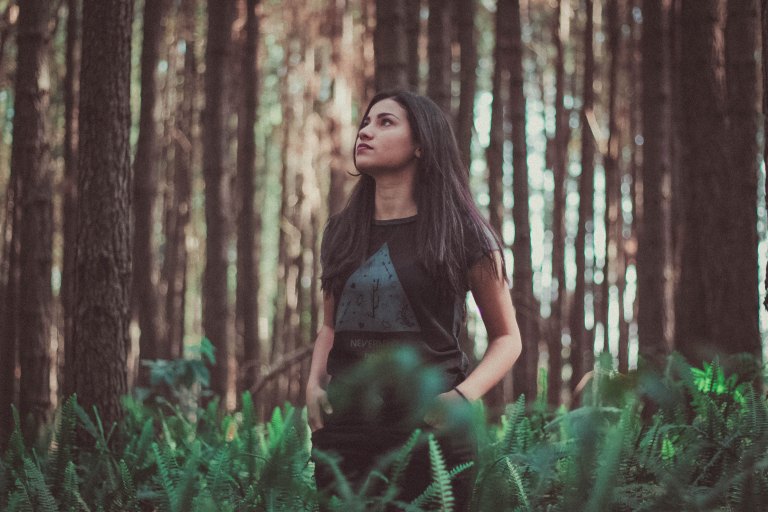 Woman standing in woods