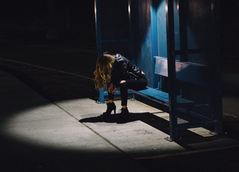 student at bus stop