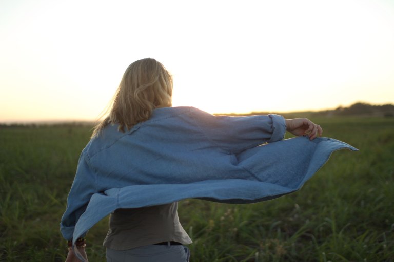 Young woman with shirt blowing in wind