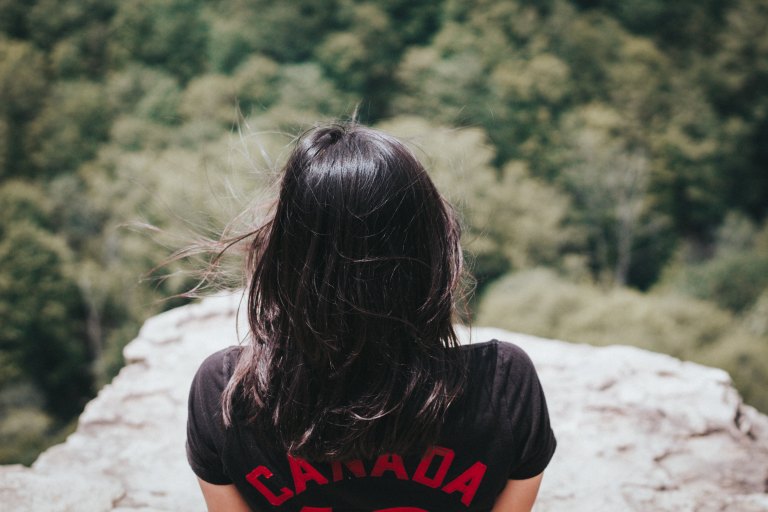 Woman standing on cliff edge