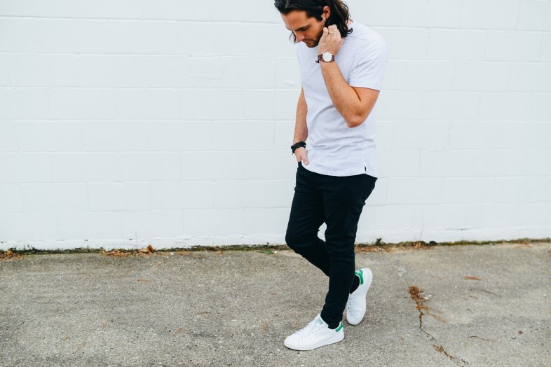 Young guy in white t-shirt on sidewalk