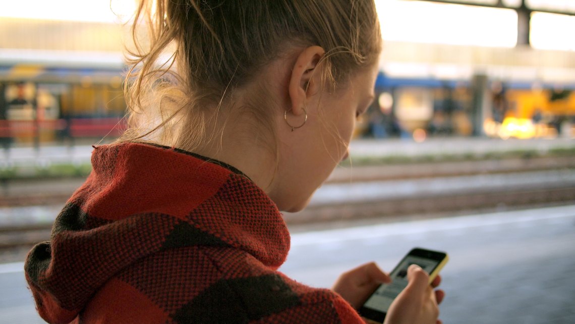 Woman looks at her phone in public 