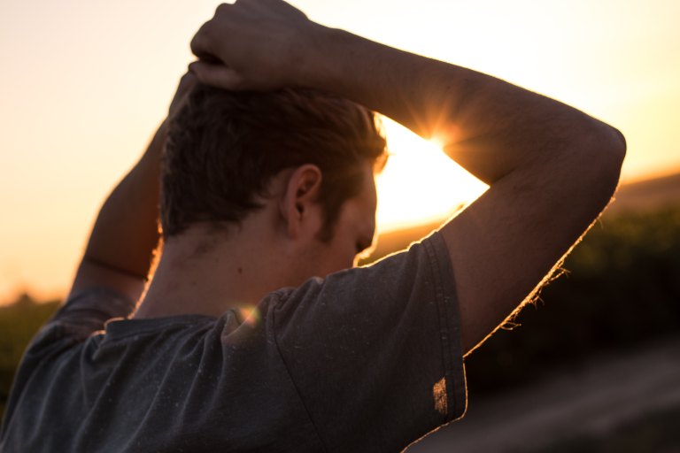 Young guy in front of sunset