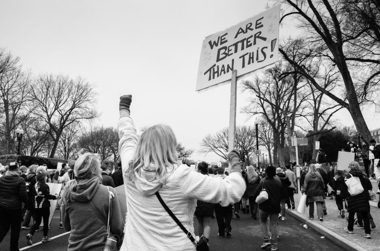 Woman holds a sign at a protest