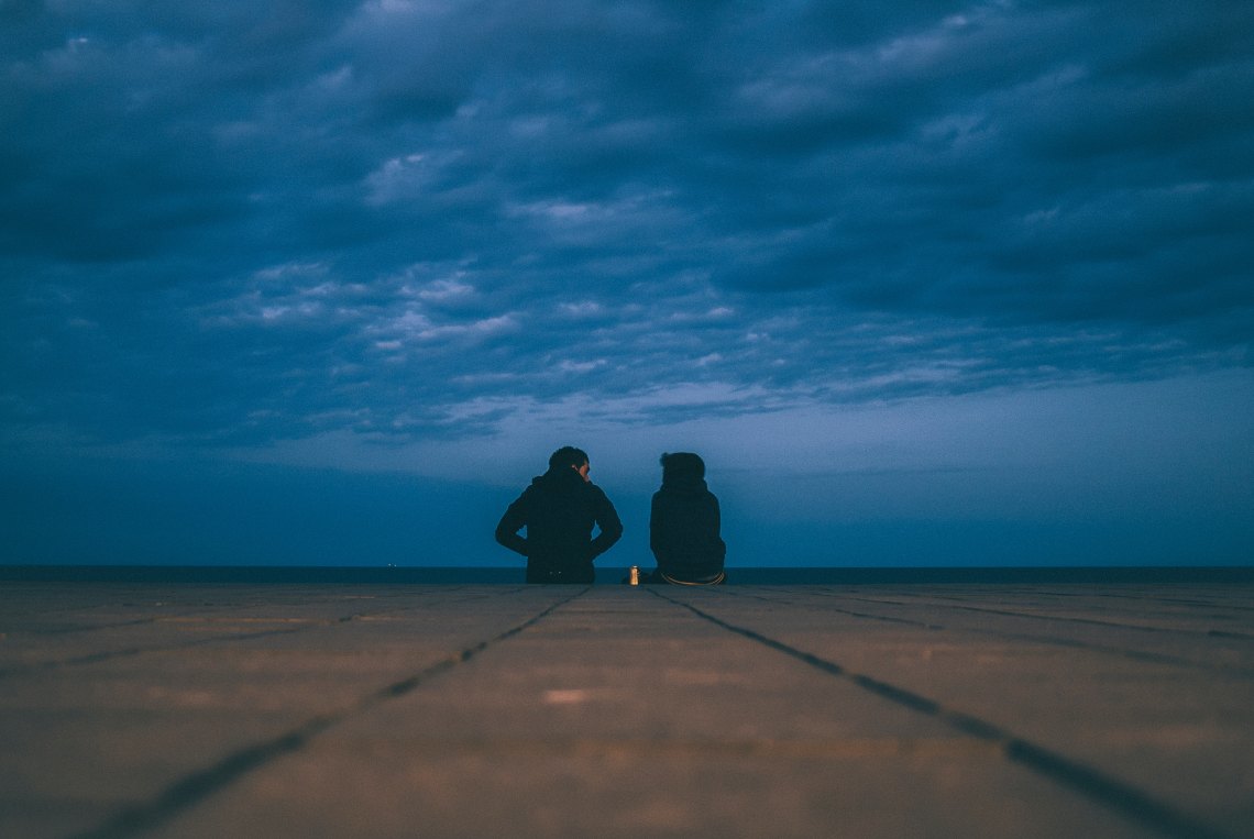 Couple Talking on rooftop in the cold 