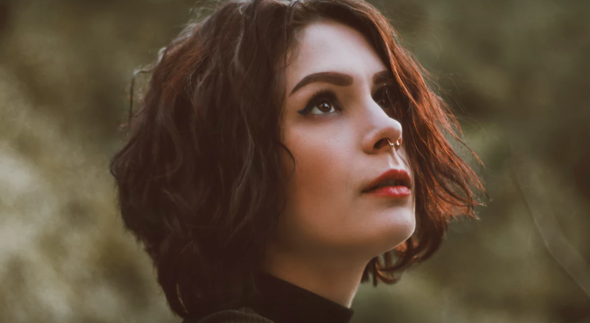 Brunette woman nose ring turtleneck