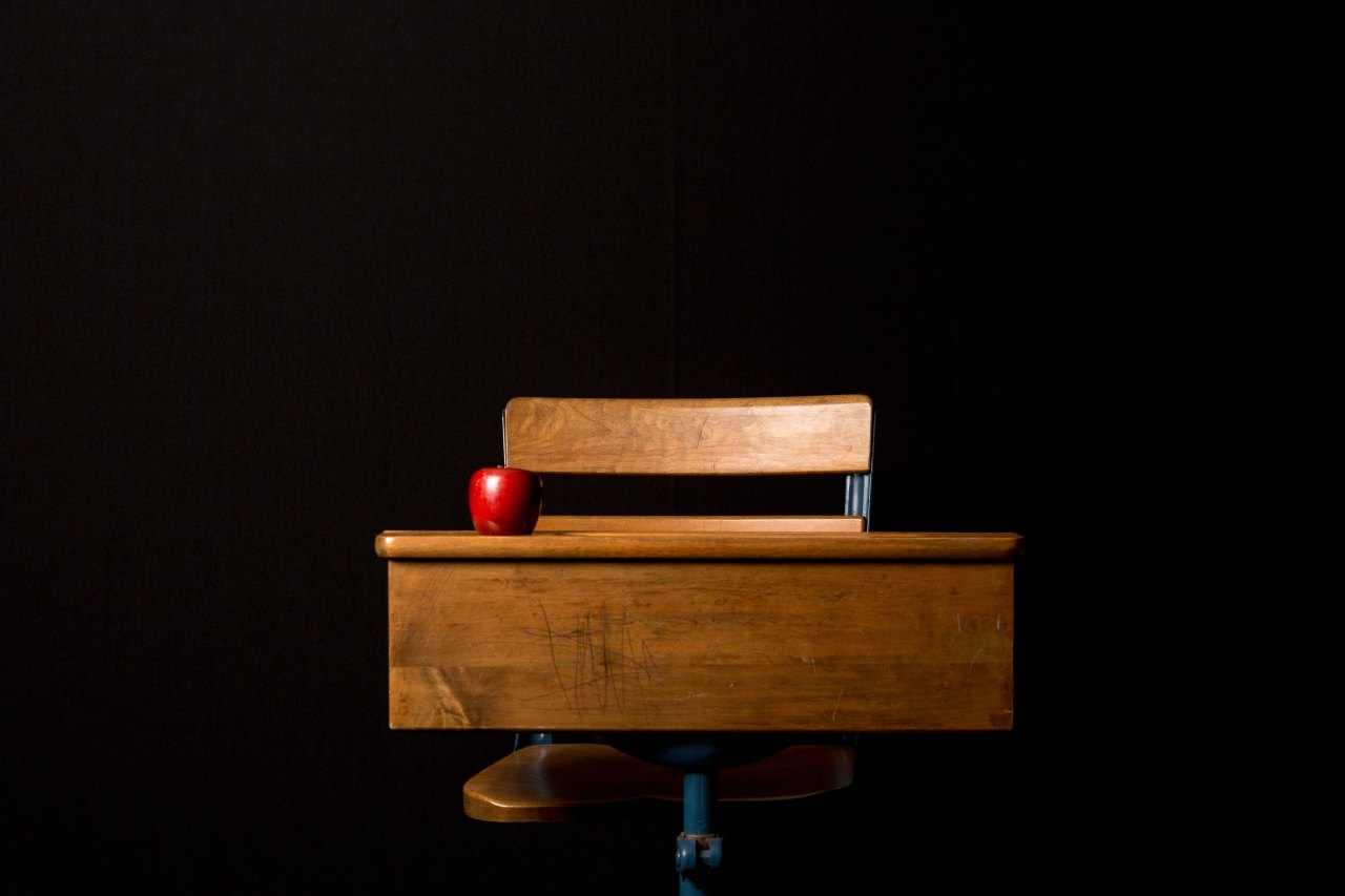 a school desk with an apple on it