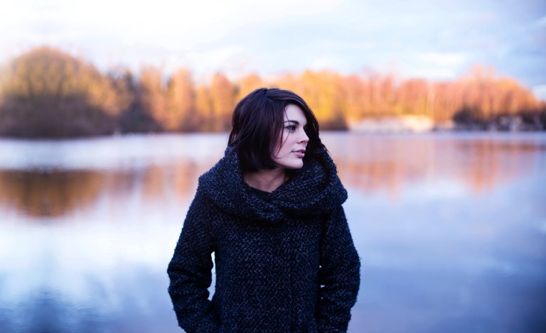 Woman standing over fall lake