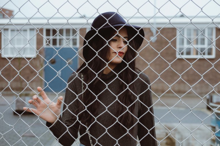 Woman behind fence