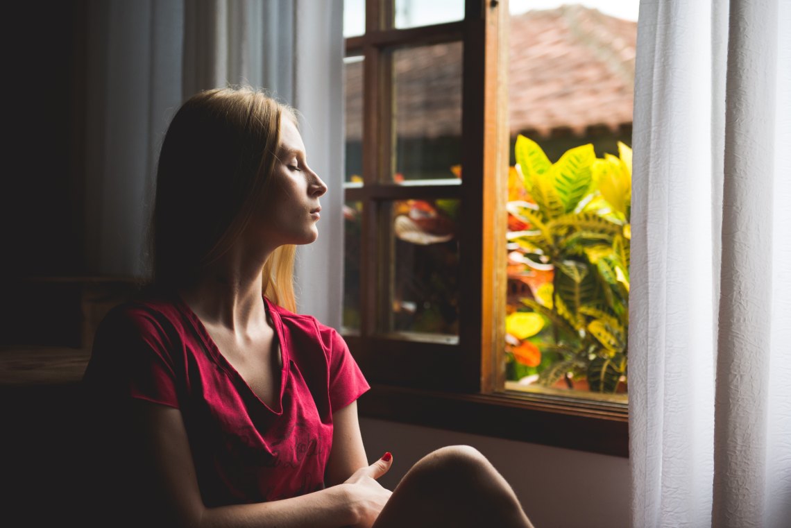 woman looking out window