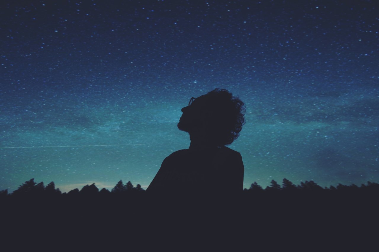 man staring at night sky