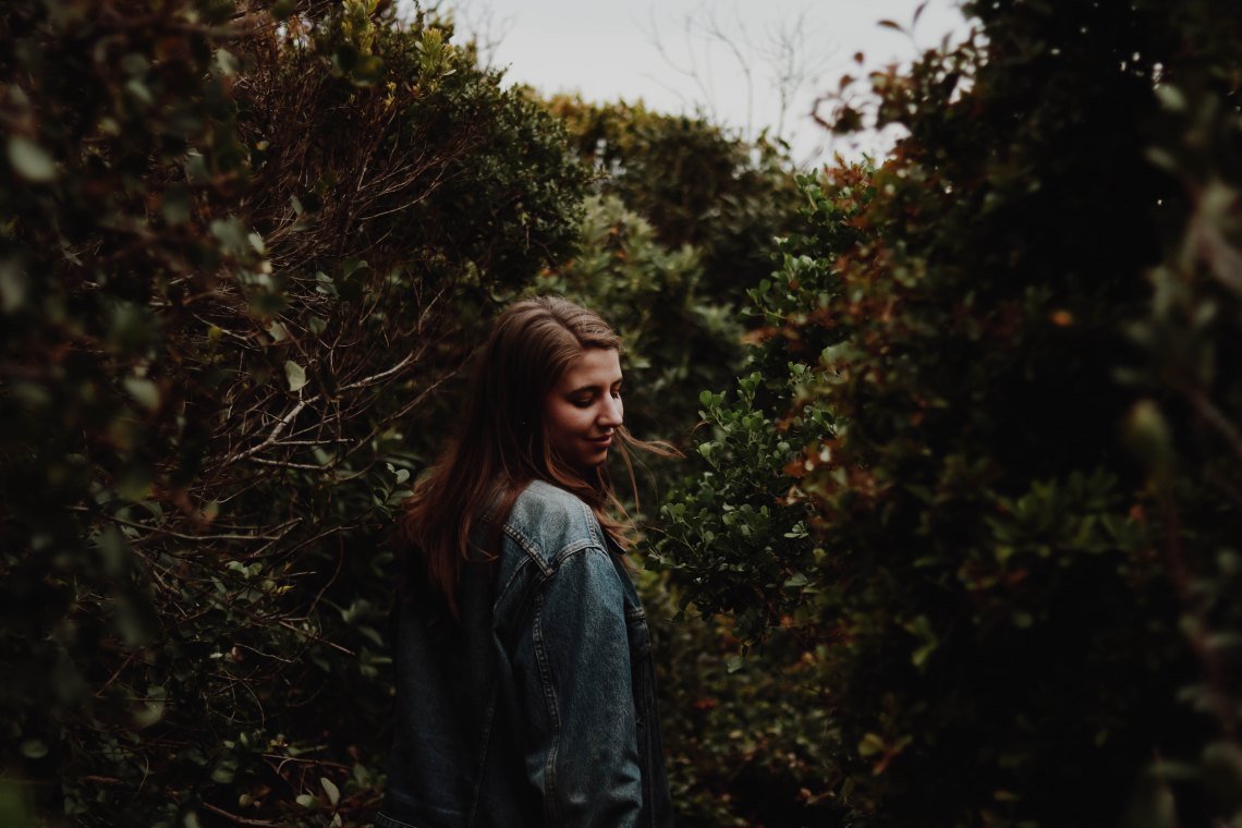 girl in forest, praying, letting God's will be done, giving it to God