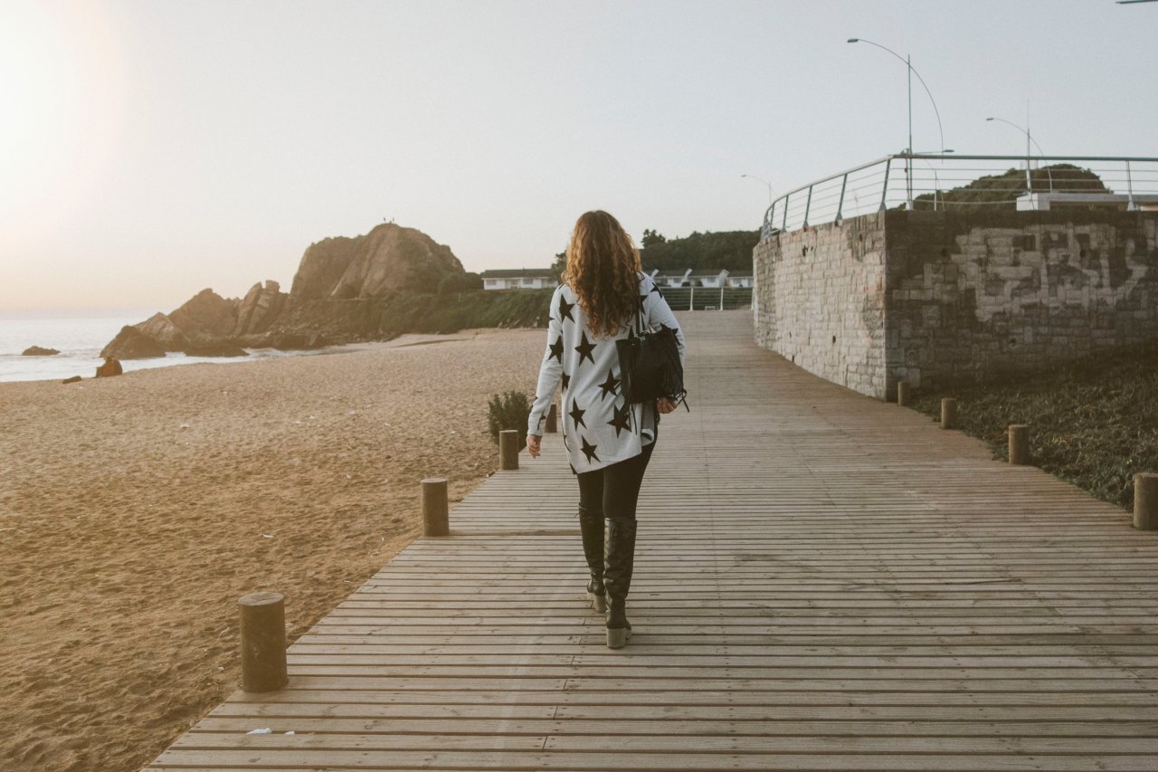 woman walking on boardwalk