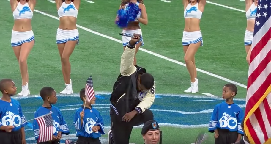 Singer kneels during the national anthem at an NFL game