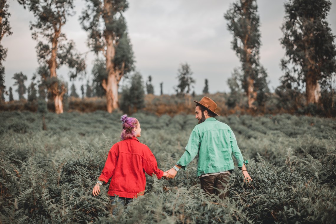 happy couple, couple walking in field,