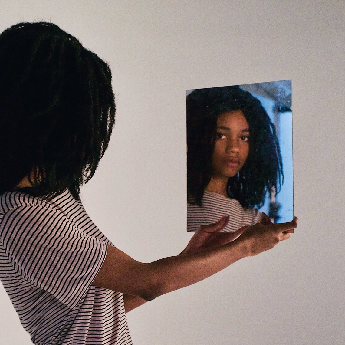 girl looking at self in mirror