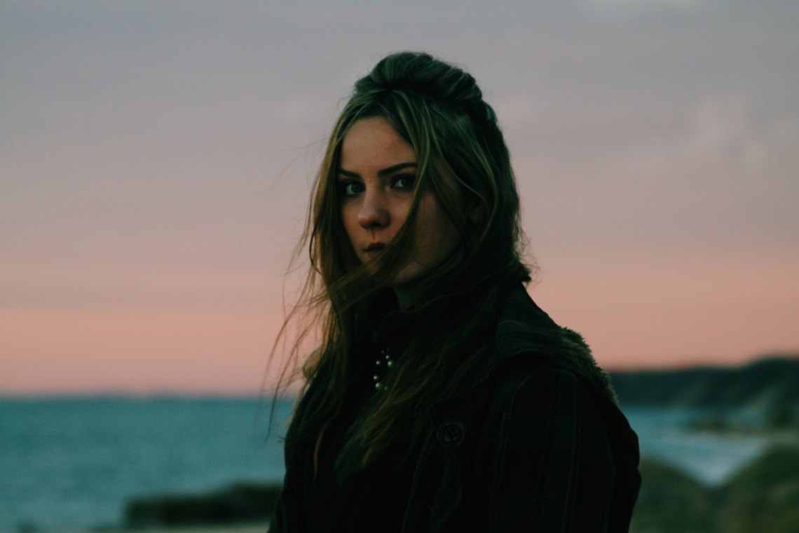 woman standing at sunset