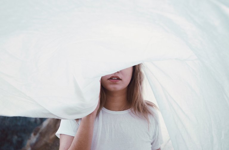 woman holding blowing sheet