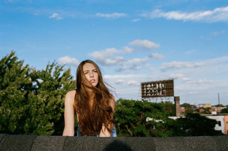 girl with long brown hair looking ahead