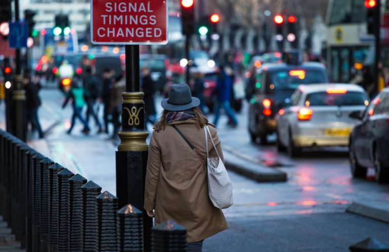 Woman walking down a busy street in the city