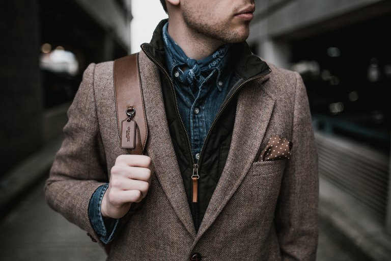 Man wearing nice clothes and a backpack