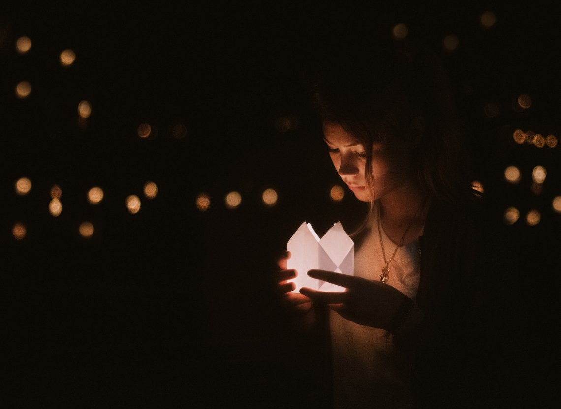 girl looking at box, dark, girl surrounded by lights, healing reminders, healing after abuse