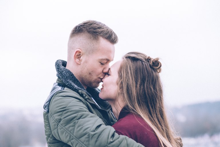 Guy kissing girl on forehead