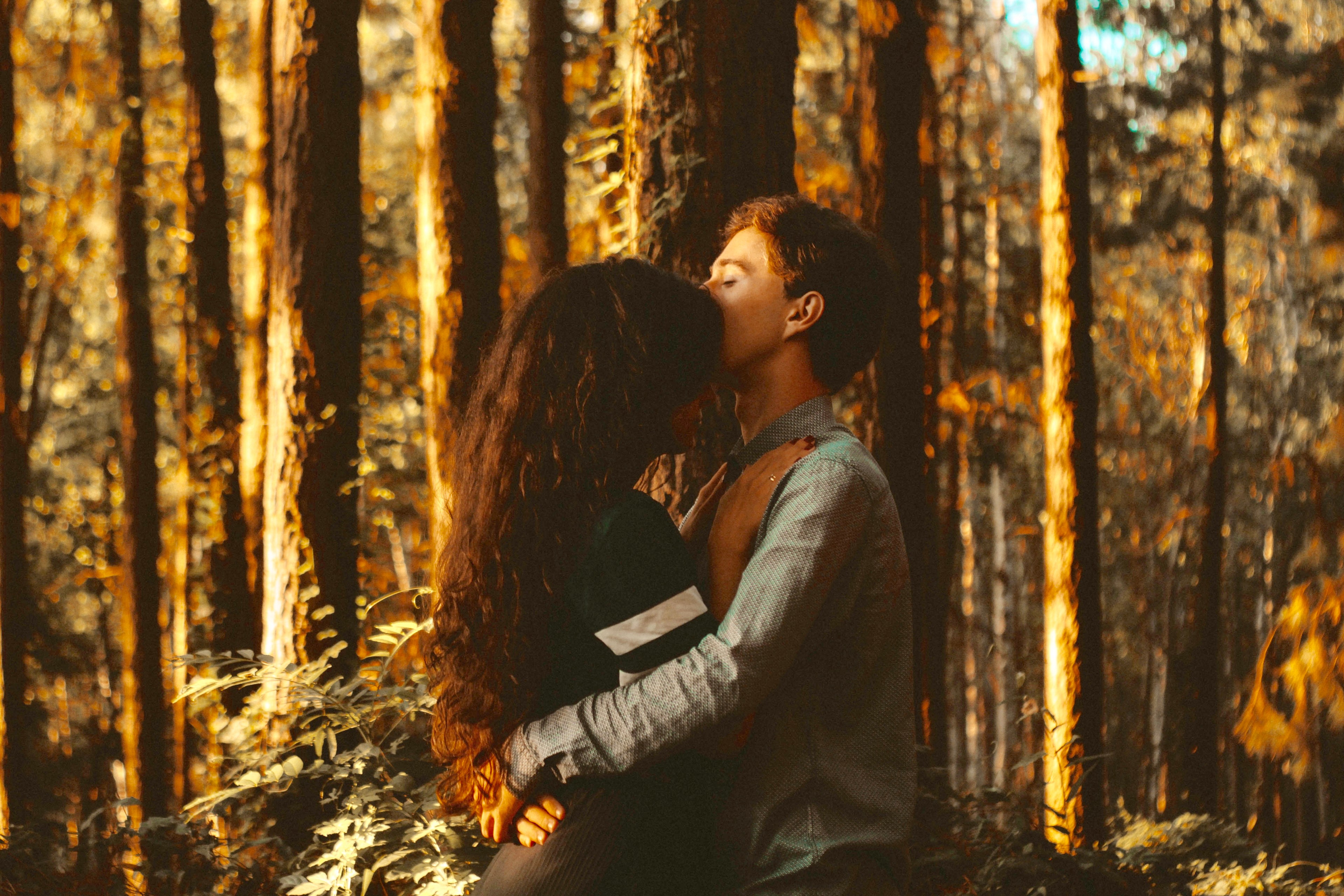 Couple hugging in forest