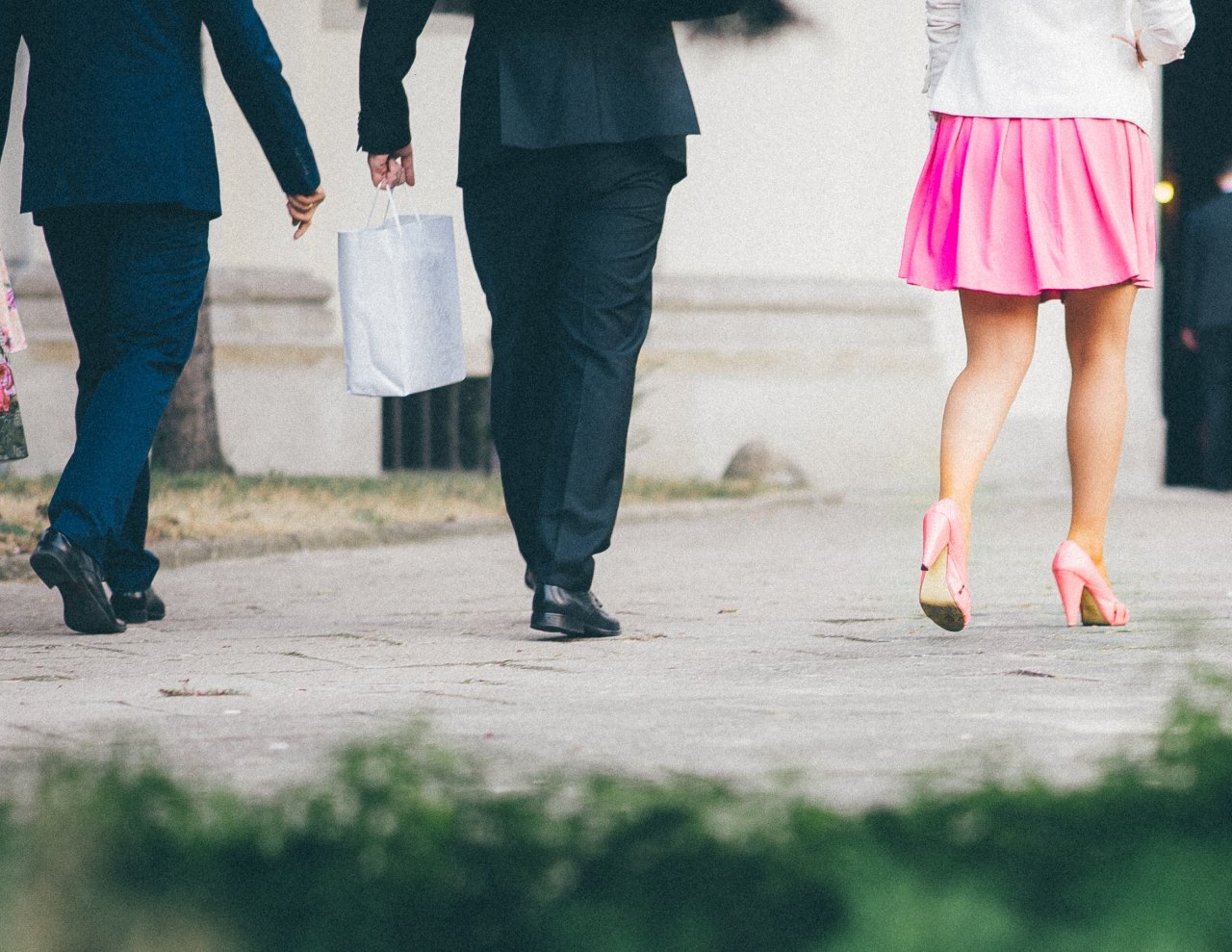 two men and a woman in professional wear