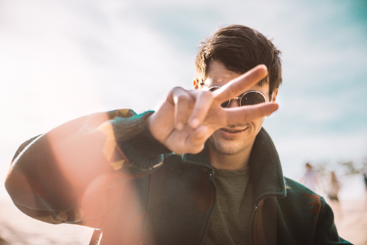 Cute guy holding up peace sign