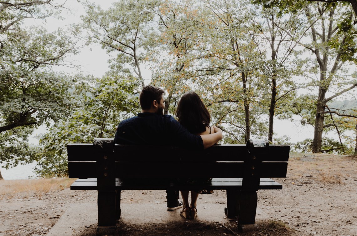 Couple sitting outside on bench