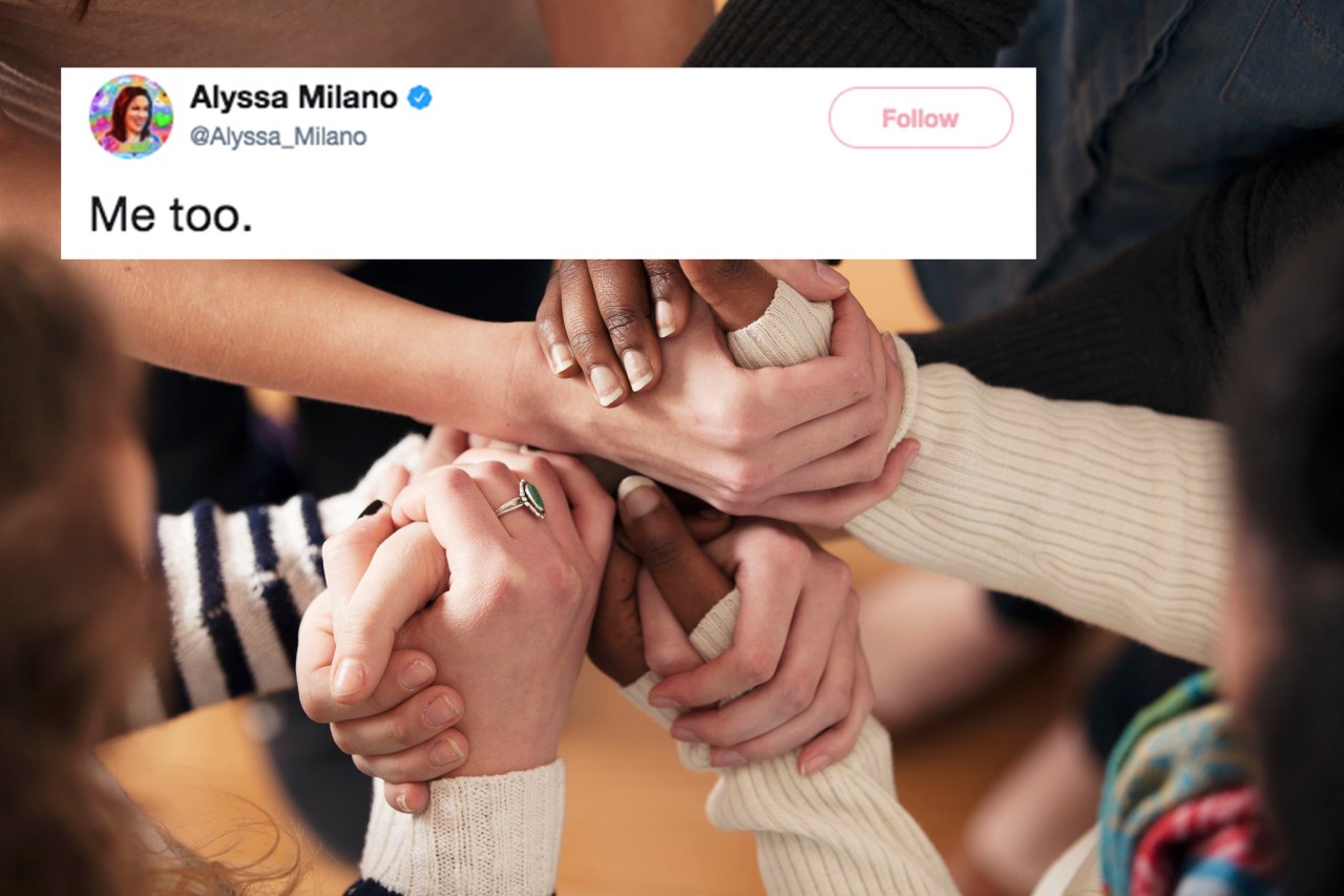 women clasp hands together in solidarity