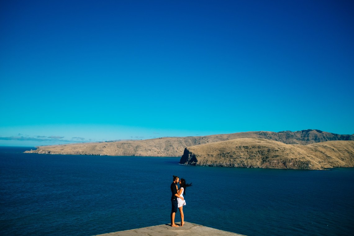 Couple embracing in front of ocean