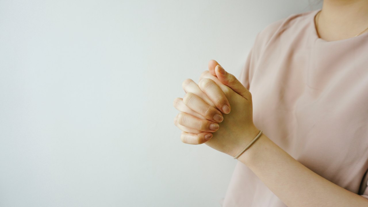 A woman wears a pink sweater for breast cancer awareness