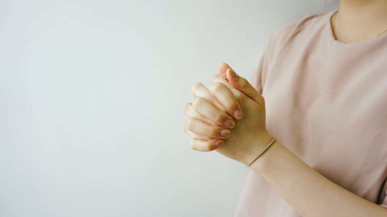 A woman wears a pink sweater for breast cancer awareness