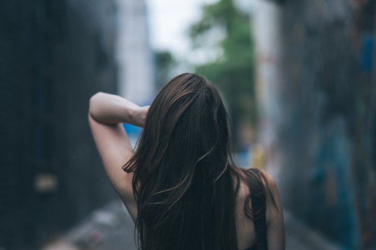 Brunette woman walking down street