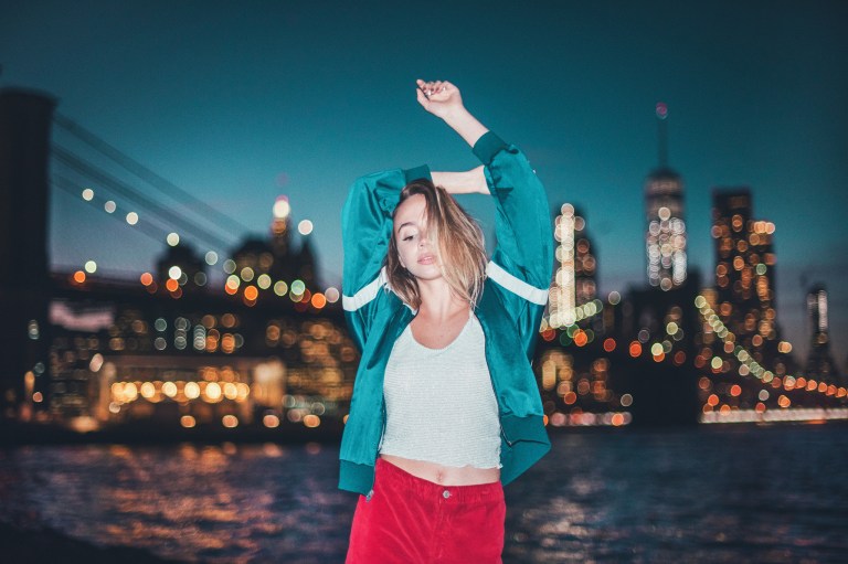 girl in front of city skyline