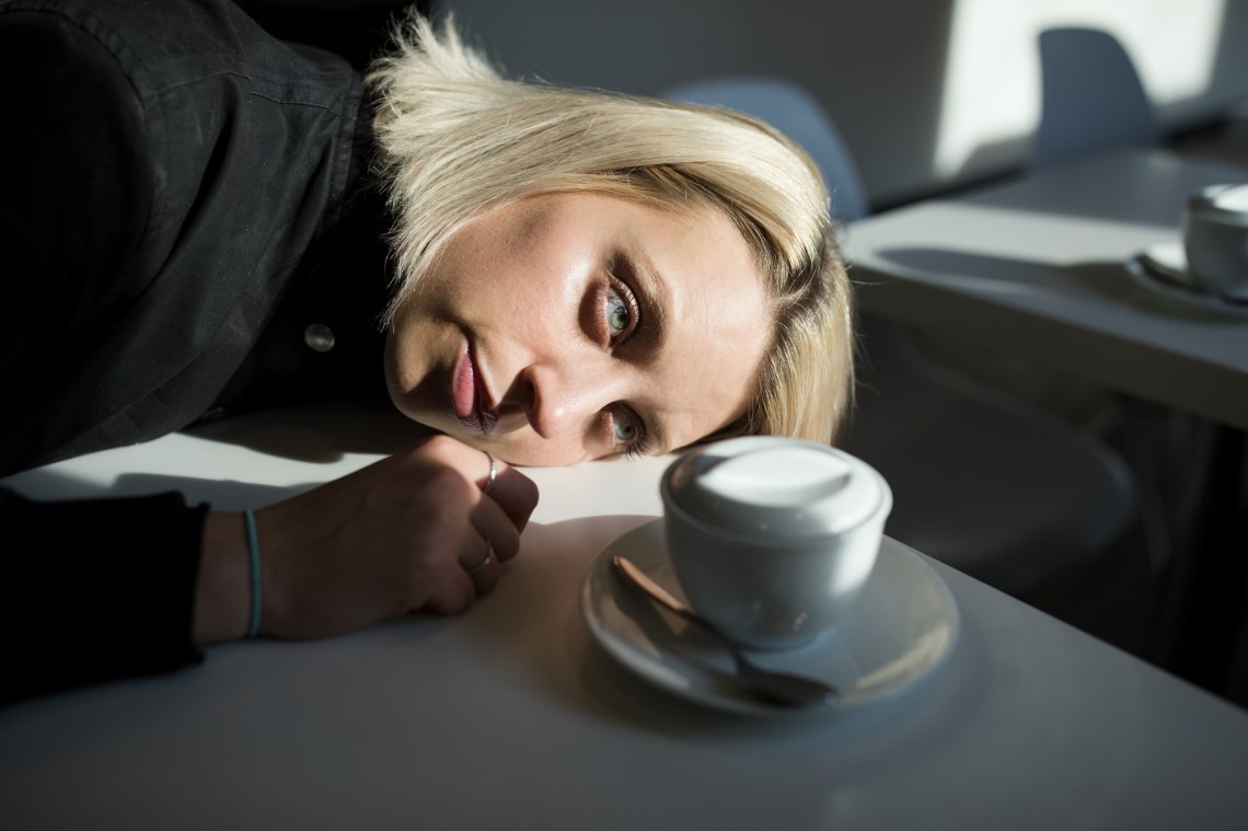 sad girl resting head on table