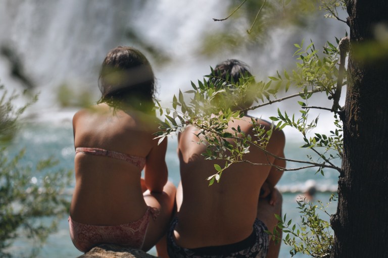 happy couple in swimsuits sitting, not afraid of heartbreak, not afraid to love