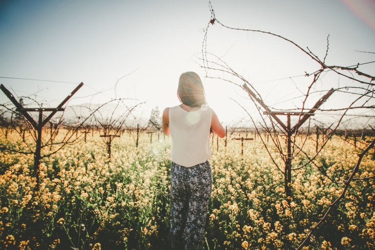 Girl standing in meadow