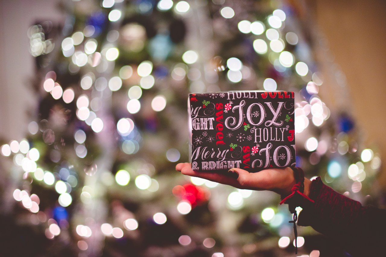 A christmas gift in front of a christmas tree