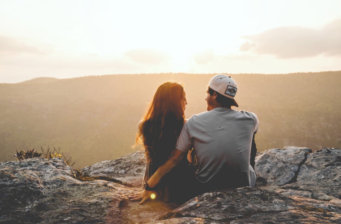 Couple hugging on mountaintop