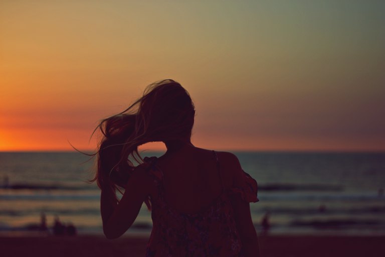 Woman's silhouette in front of ocean