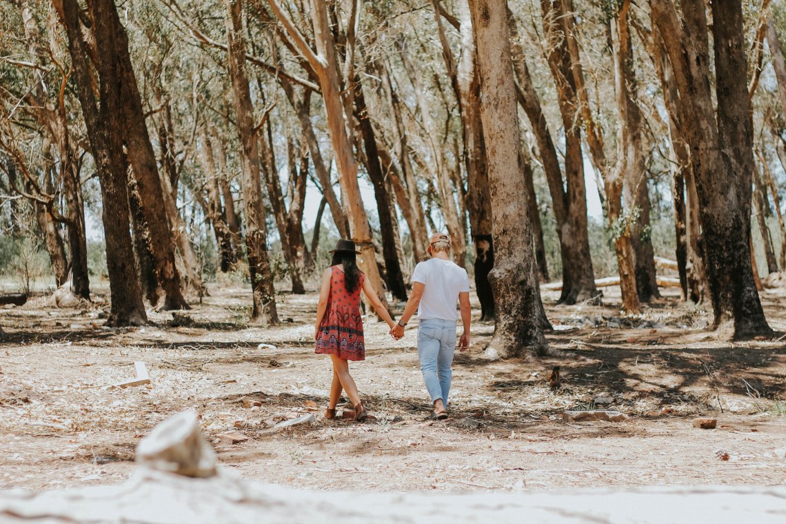 couple walking through forest, happy couple, based on the love languages, love languages