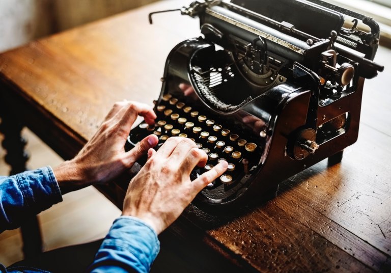 person types on a typewriter